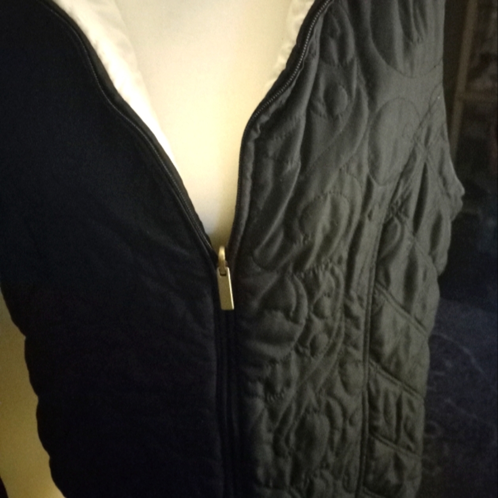 Used,not new,never worn  reversible black/cream sleevless quilted zip up vest.